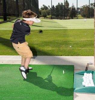 Boy playing golf.