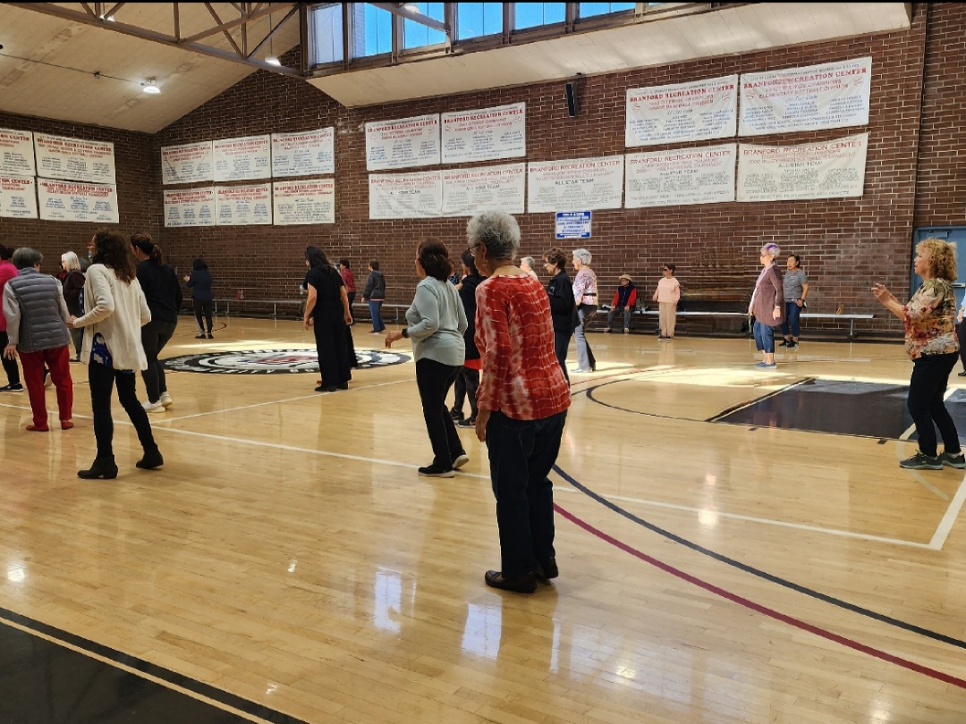 seniors dancing in an indoor gym